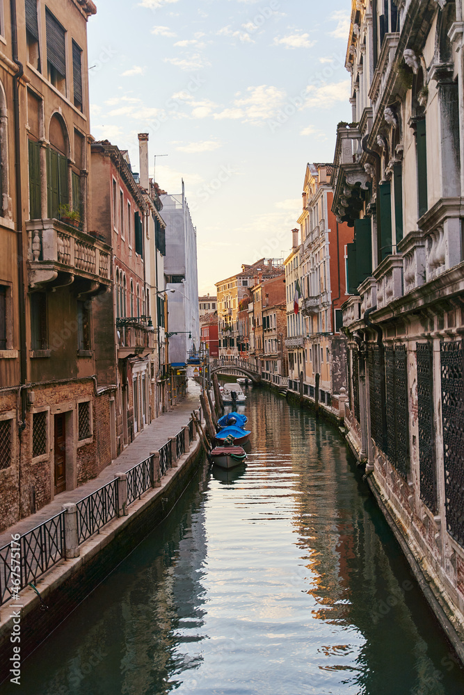 Venice, Italy - 10.12.2021: Traditional canal street with gondolas and boats in Venice, Italy.