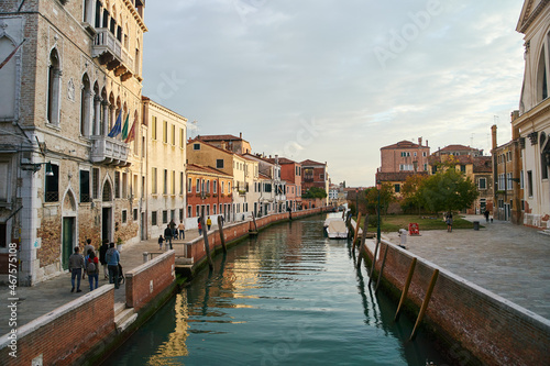 Venice, Italy - 10.12.2021: Traditional canal street with gondolas and boats in Venice, Italy.