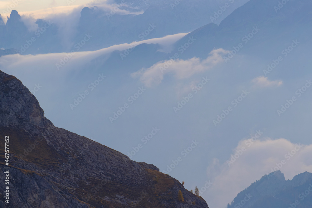 Fototapeta premium Clouds among the clifs and the rock of Dolomites mountains