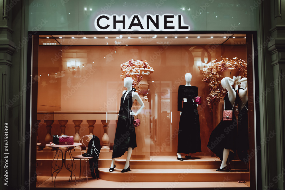 Female stylish mannequins in a shop window with Chanel bags. Chanel is a  high fashion brand founded by Coco Chanel in 1909 Stock Photo