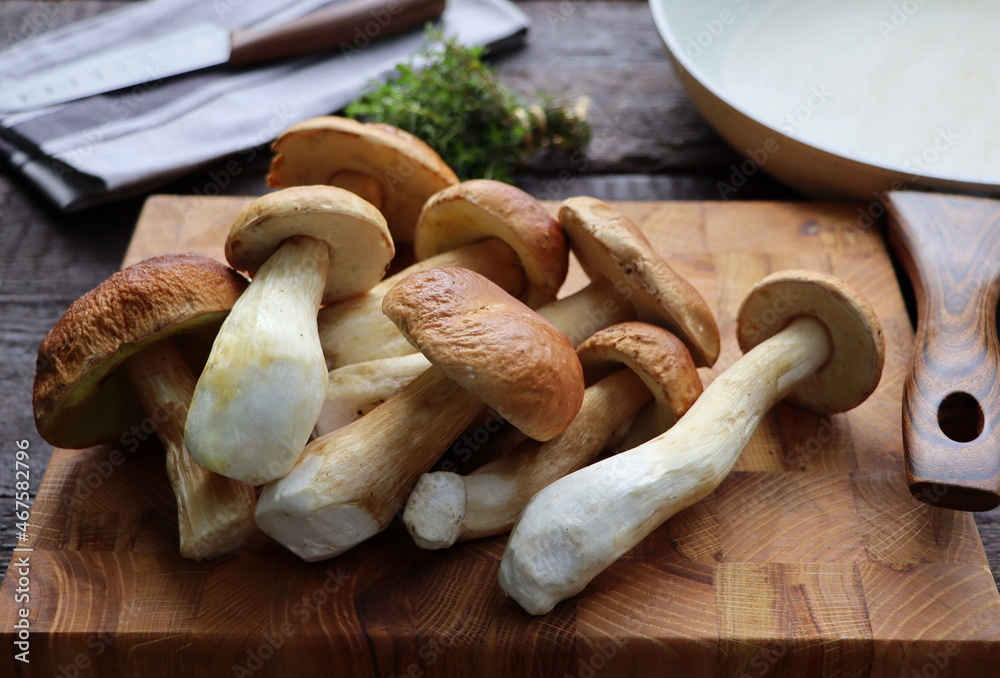 Mushrooms boletus over wooden background. Autumn cep mushrooms. Mushrooms picking and cooking Mushrooms boletus over wooden background. Autumn cep mushrooms. Mushrooms picking and cooking