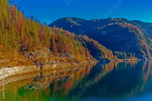 Bright autumn landscape, golden foliage over the lake