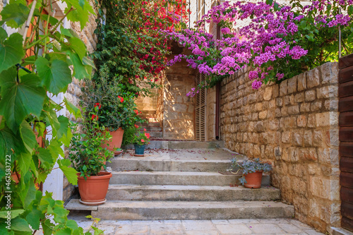 Mediterranean summer cityscape - view of a medieval street with stairs and flowers in the Old Town of Hvar, the island of Hvar, the Adriatic coast of Croatia