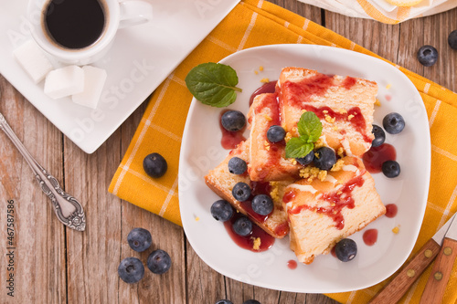 Lemon pund cake with blueberries and strawberry syrup. photo