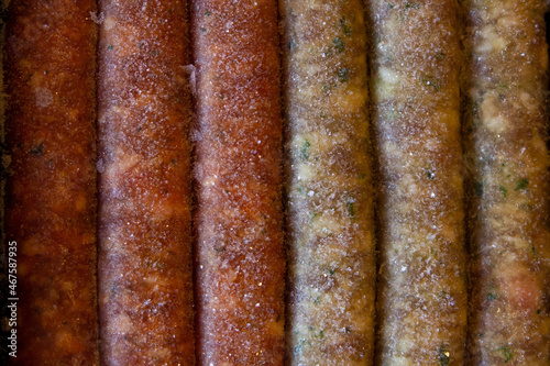 Raw frozen sausages kupaty, assorted. Background, top view.
