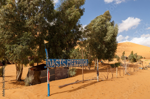 Oasis Merzouga. Information signboard at the entrance to the camp. Sahara Desert. Erg Chebbi. Morocco photo
