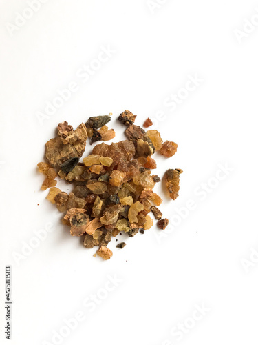 Myrrh is a natural gum or resin extracted from a number of small, thorny tree species of the genus Commiphora Isolated on white photo