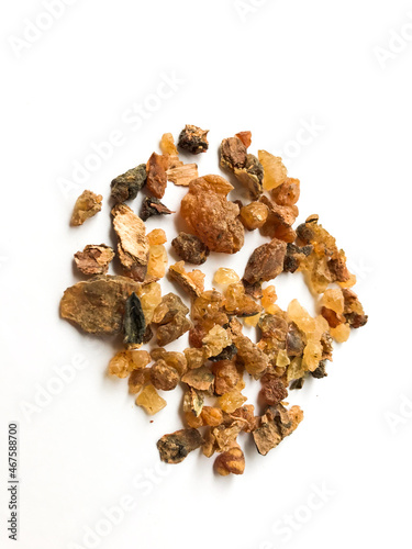 Myrrh is a natural gum or resin extracted from a number of small, thorny tree species of the genus Commiphora Isolated on white