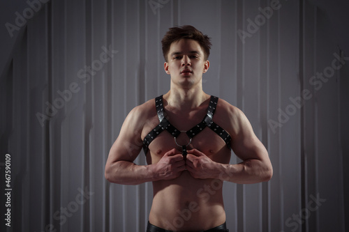 Muscular sexy guy in a harness.