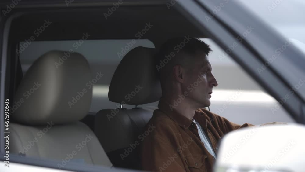 Upset man smoking cigarette and pondering about life, sitting in car, problems Upset man smoking cigarette and pondering about life, sitting in car, problems