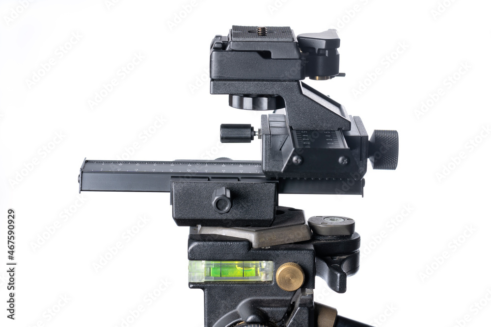 Aluminum 4-way macro photography focus slider mounted on a tripod isolated on white Aluminum 4-way macro photography focus slider mounted on a tripod isolated on white