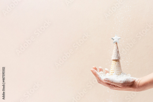 Christmas tree of waffle cones and falling snow of sugar, festive background