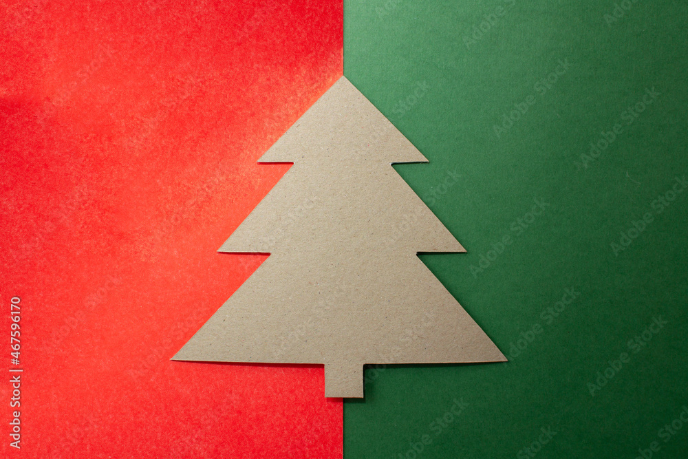 Fototapeta premium Cardboard tree on a red-green background without decorations.