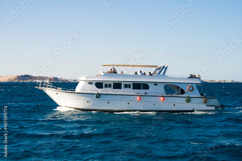 A small ship with tourists floats on the sea  Red sea. Egypt © sergkul