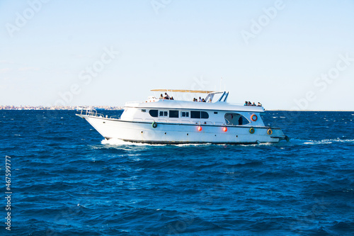 A small ship with tourists floats on the sea  Red sea. Egypt © sergkul