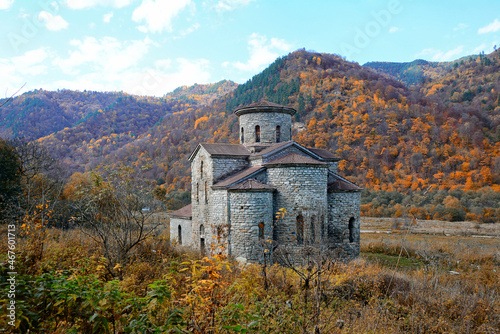 Karachay-Cherkessia, Arkhyz, Russia, autumn 2021. View of the Middle Zelenchuk temple of the 10-13th century against the background of autumn mountains