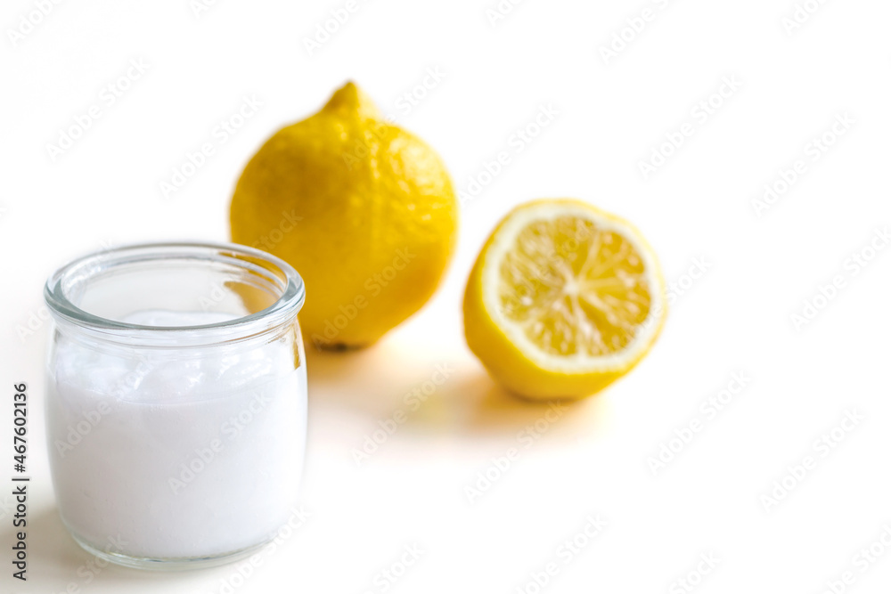 Cosmetic product for skin care. In the foreground is a glass jar with cream. There are lemons in the background. Space for text. Concept: cosmetology, spa, healthy nutrition, medicine, vitamins. Cosmetic product for skin care. In the foreground is a glass jar with cream. There are lemons in the background. Space for text. Concept: cosmetology, spa, healthy nutrition, medicine, vitamins.