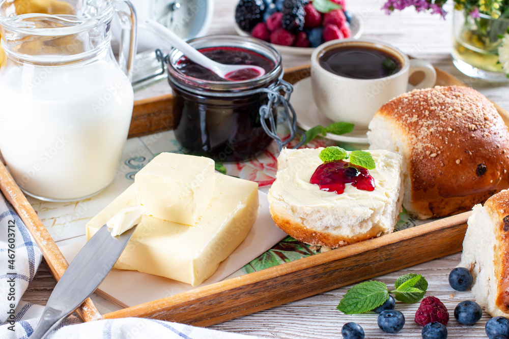 Homemade fresh buns served with butter and jam. Homemade fresh buns served with butter and jam.
