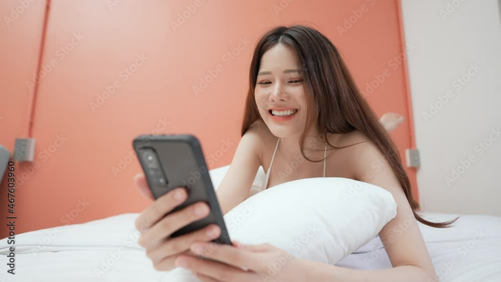 Holiday concept of 4k Resolution. Asian girls playing cell phones in the bedroom. social network. Internet communication. Holiday concept of 4k Resolution. Asian girls playing cell phones in the bedroom. social network. Internet communication.