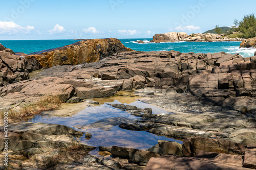 Rocks, Waves and sand on the beach photo