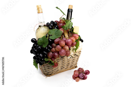 basket with grapes  bottles of red and white wine  cheese. picnic basket