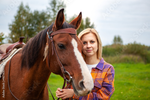 Beautiful young blond woman with a horse, portrait. © наталья саксонова
