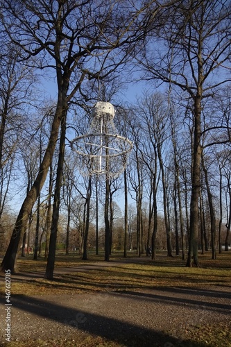 nusual interesting shape white lamp hanging on a tree in Kadriorg park. Sunny weather. Autumn landscape with no people. Yellow foliage on the ground. Tallinn, Estonia, Europe. November 2021 photo