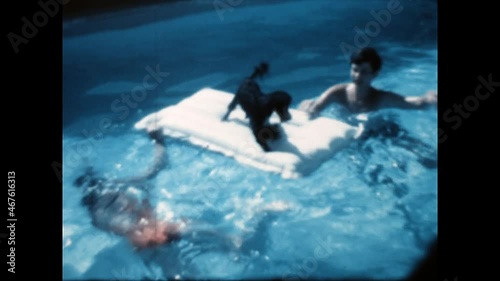 Pooch in the Pool 1970 - A dog and two children play in a pool in Beverly Hills, California in 1970.  photo