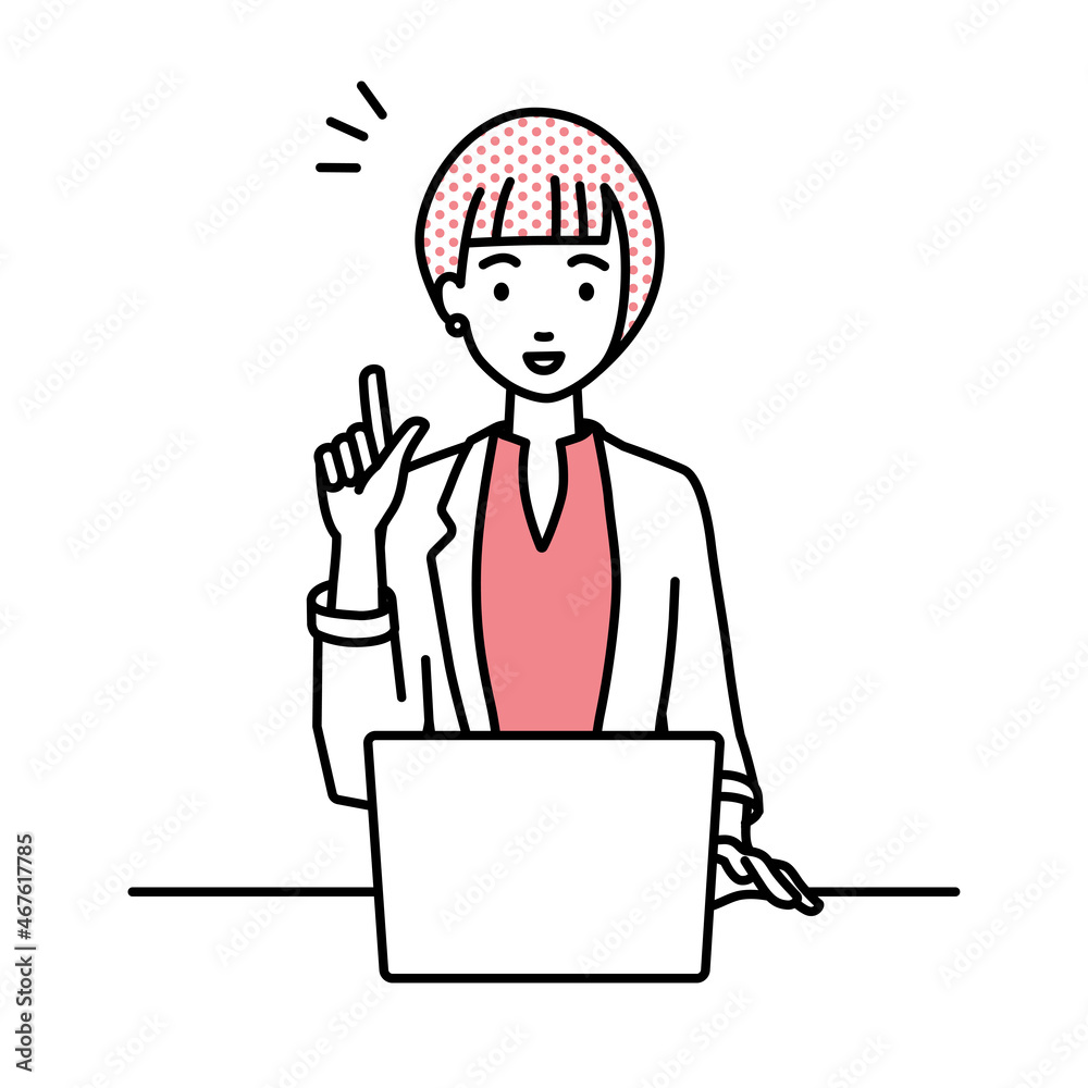 デスクで座ってPCを開いて何かひらめいたジャケットの女性