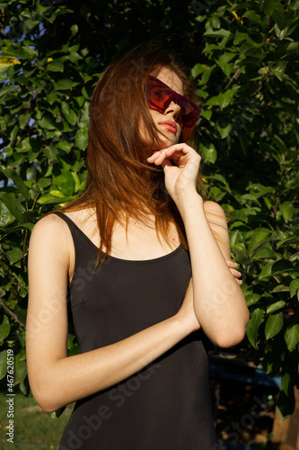pretty woman wearing sunglasses summer nature posing