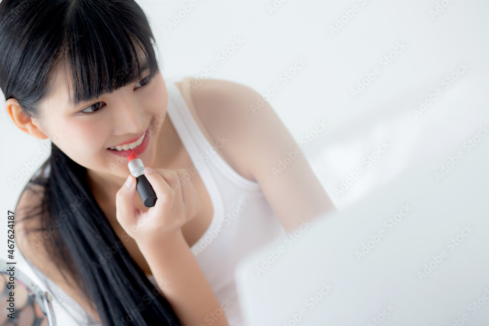 Beauty of young asian woman with learning makeup with lipstick on mouth watching laptop computer with tutorial course online on bed, female teaching and explain make up with cosmetic on streaming. Beauty of young asian woman with learning makeup with lipstick on mouth watching laptop computer with tutorial course online on bed, female teaching and explain make up with cosmetic on streaming.