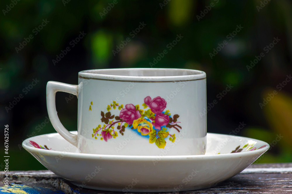 Fototapeta premium A vintage porcelain tea cup with flower motif