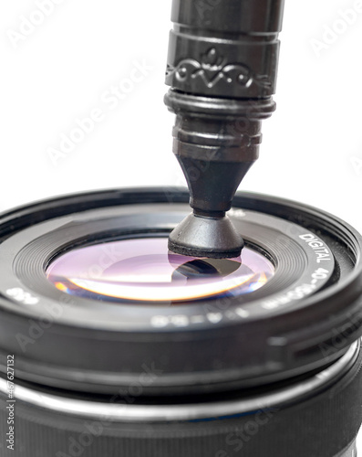 camera lens cleaning through lenspen on white background