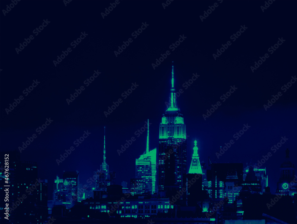 Lights of the New York City skyline buildings at night with vibrant green and blue colors