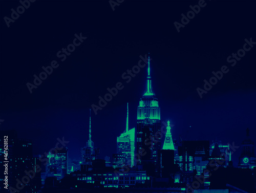 Lights of the New York City skyline buildings at night with vibrant green and blue colors