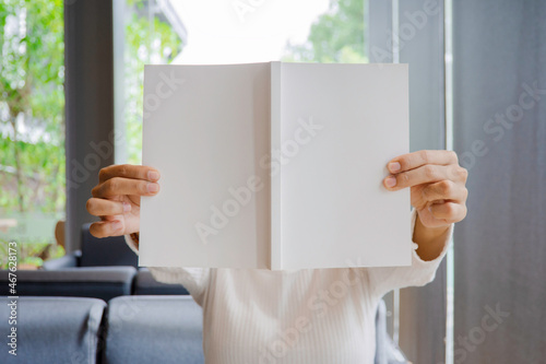 Close up empty cover of the book cover with morning light in living room, Mock up of blank cover of notebook in soft light tone