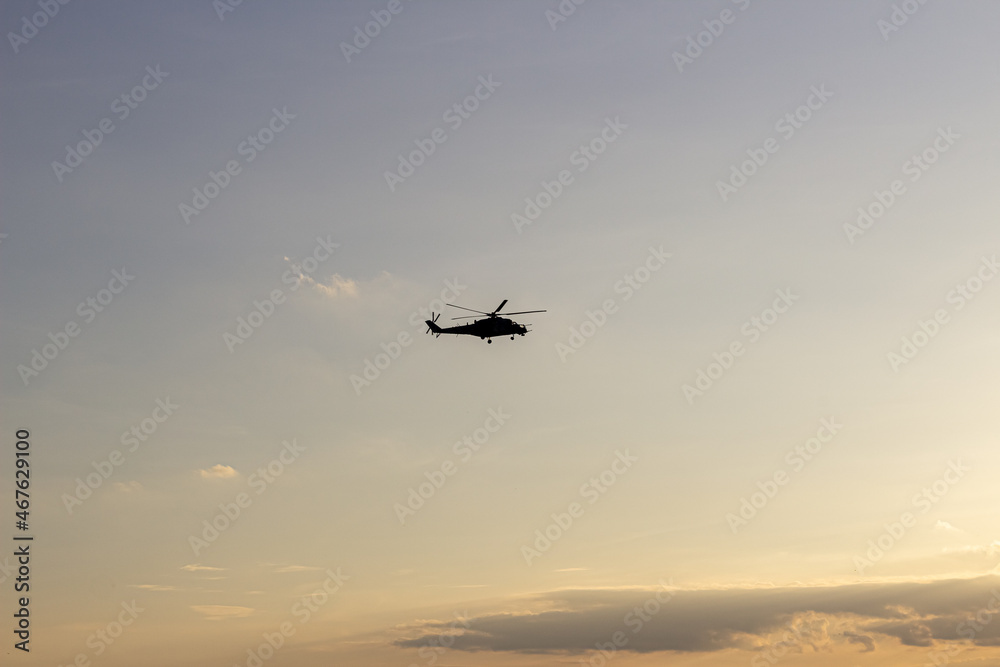 helicopter in the sky at sunset
