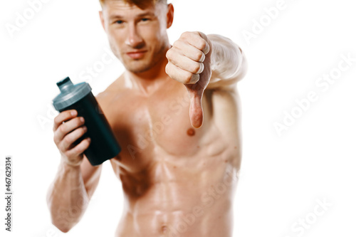 athletic man with a pumped-up torso drink bottle sportspit