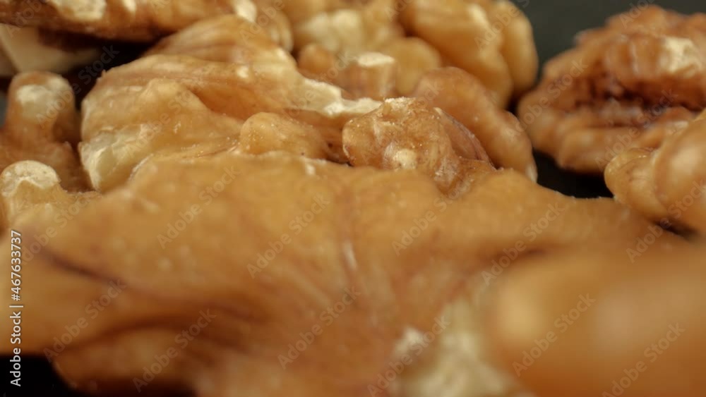 The concept of making oil from walnuts. Lots of ripe walnut seeds, close-up. A product with a high protein content. High quality. 4k footage. The concept of making oil from walnuts. Lots of ripe walnut seeds, close-up. A product with a high protein content. High quality. 4k footage.