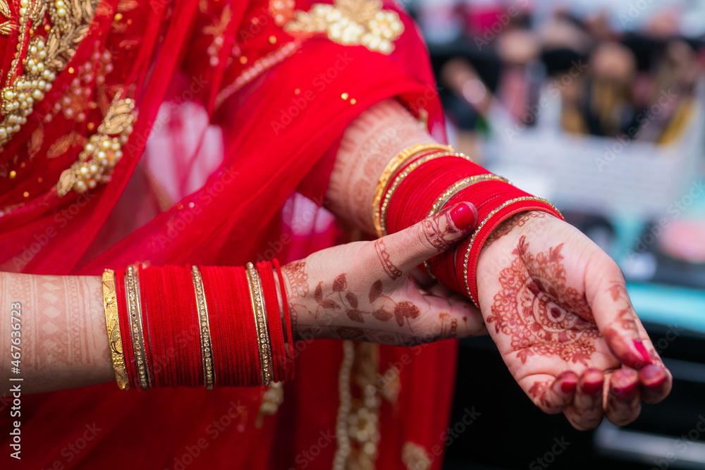 Indian bride's wearing her jewellery and bangles hands close up