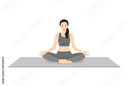 Easy Pose, Beautiful girl practice Sukhasana. Young attractive woman practicing yoga exercise. working out, black wearing sportswear, grey pants and top, indoor full length, calmness and relax.
