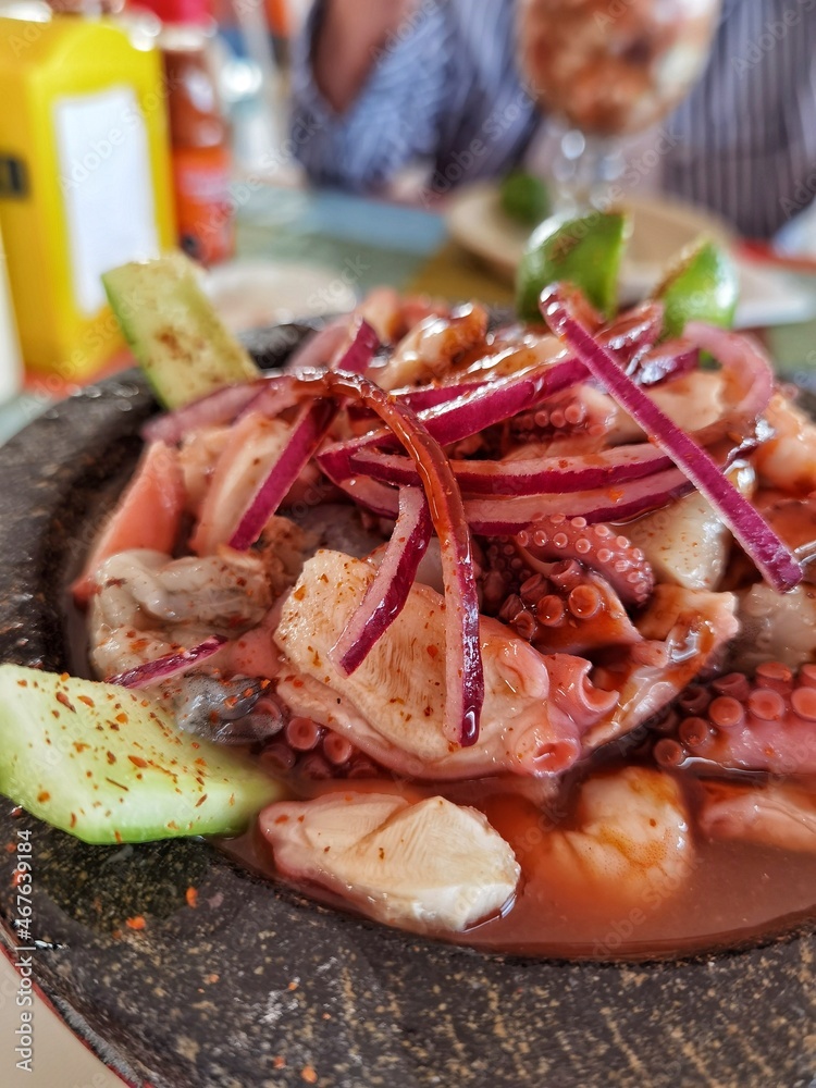 seafood on a grill, shrimps and octopus cocktail by the sea 