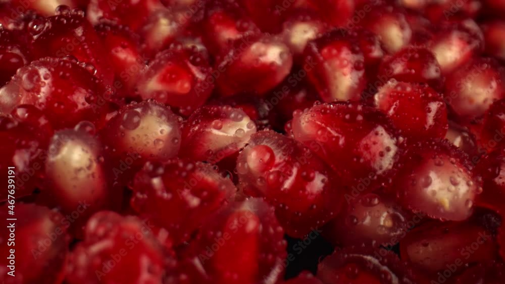 Pomegranate grains for decorating dishes and soft drinks. Transparent drops of water flow from the grains of the pomegranate. Fresh fruit grown on the farm. High quality. 4k footage. Pomegranate grains for decorating dishes and soft drinks. Transparent drops of water flow from the grains of the pomegranate. Fresh fruit grown on the farm. High quality. 4k footage.