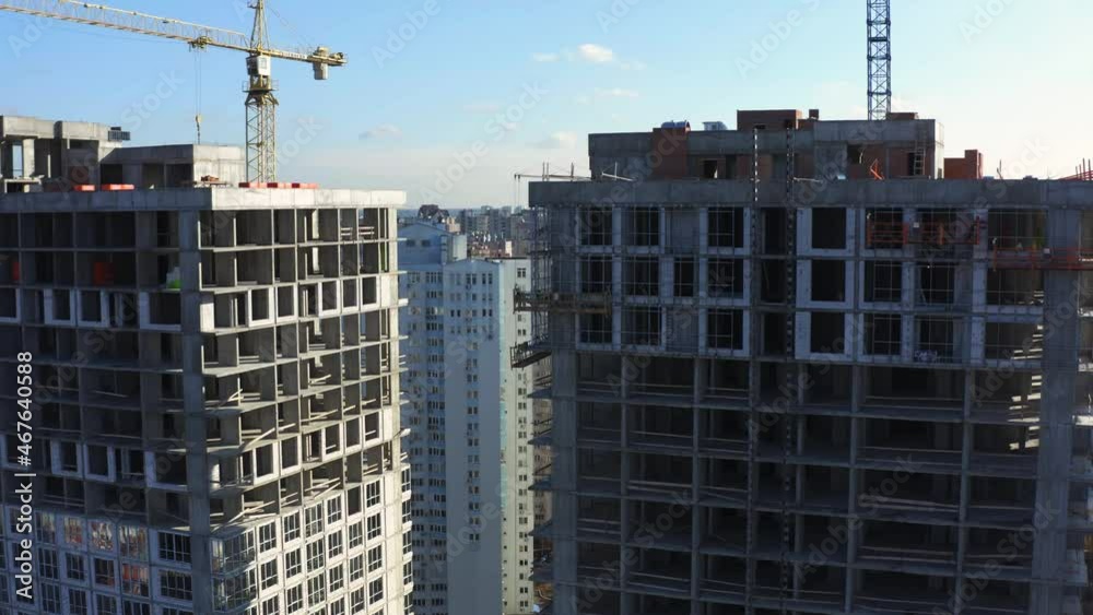 Fly over the construction site, work as construction personnel, builders work, construction houses. Aerial Flight Over a New Constructions Development Site with High Tower Cranes Building Real Estate. Fly over the construction site, work as construction personnel, builders work, construction houses. Aerial Flight Over a New Constructions Development Site with High Tower Cranes Building Real Estate.
