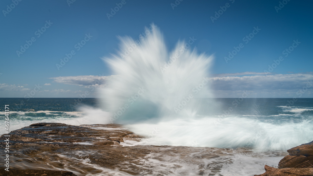 Wave Exploding On Rocks