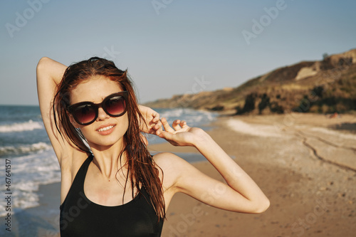 cheerful woman sunglasses posing black swimsuit island