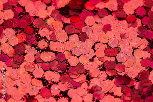 Full frame macro abstract texture background of sparkling red glitter with bokeh