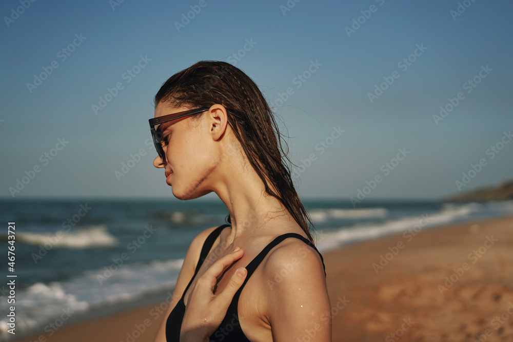 cheerful woman in black swimsuit sunglasses beach walk travel