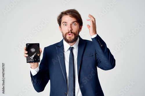 emotional business man with hard drive on computer technology