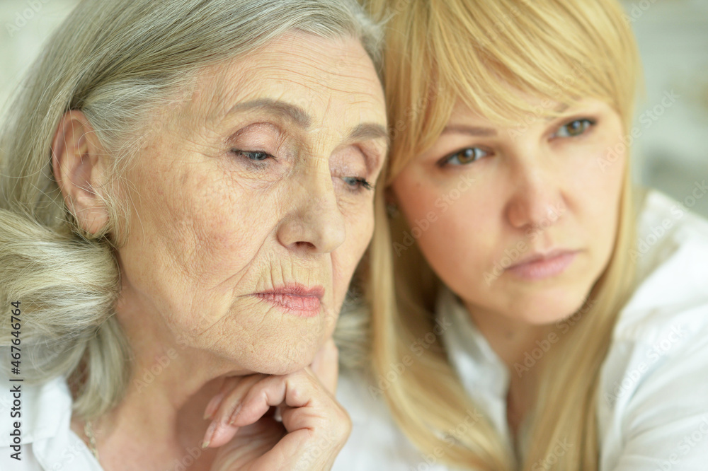 Portrait of sad senior woman with daughter Portrait of sad senior woman with daughter